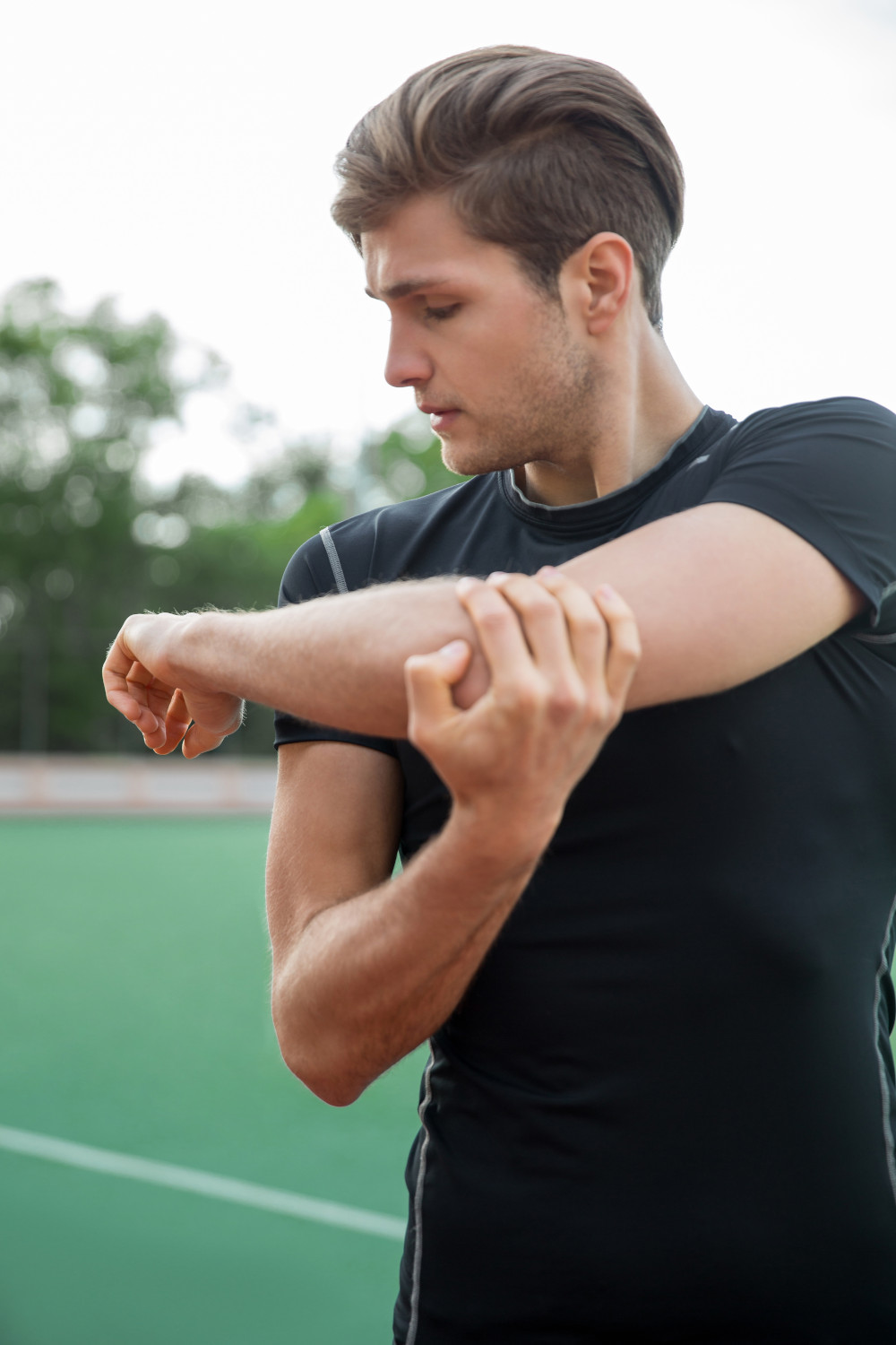 man looking at his wrist pain